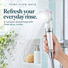 Pure Flow Bath white travel filter showerhead — spray view